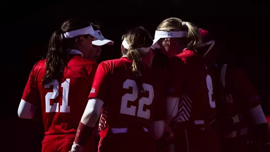 Boston University softball players huddle in the circle.