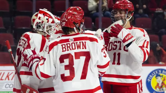 The men's ice hockey team celebrates a win
