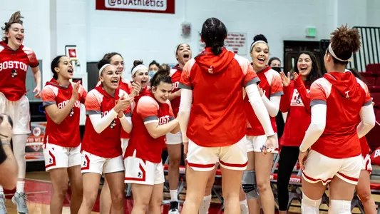 The BU women's basketball team celebrates as a team before the matchup against Bucknell.