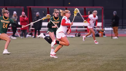 Jenny Feeney races up the field with the ball.