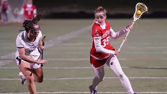 Caroline Pinho eludes a Holy Cross defender.