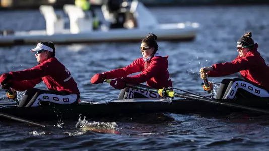 BU women's rowing eight boat rows down the Charles River