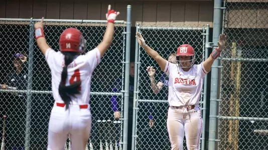 Marina Sylvestri greets Jen Horita at home plate with arms raised high
