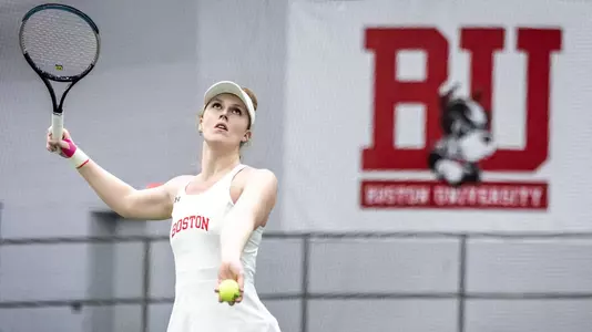 Nina Gulbransen gets ready to toss the ball up for a serve attempt.