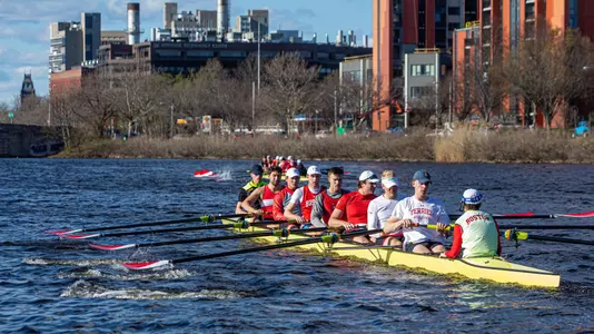The BU men's rowing team has two boats on the Charles River for a practice run.