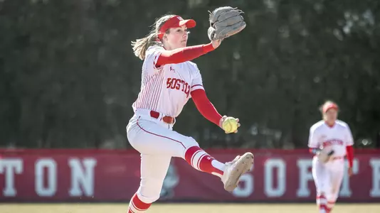Lefthander Allison Boaz is in the middle of her pitching windup to home.