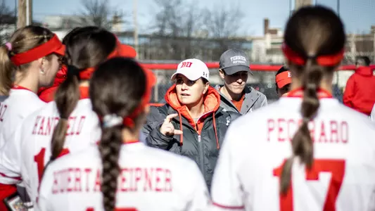 Ashley Waters talks to the BU softball team in a team huddle.