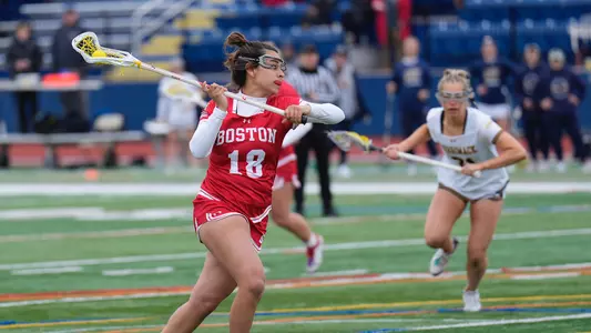 Photo of women's lacrosse junior Lauren Kaye preparing for a shot against Merrimack.