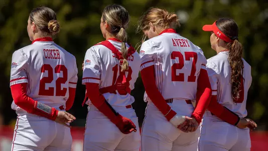 Members of the BU softball team line up for the national anthem.