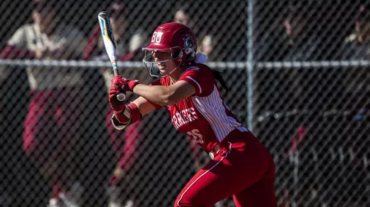 Lauren Keleher makes contact with a ball batting left handed at home plate.