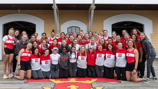2022 BU Women's Rowing Team photo taken on the dock of the DeWolfe Boathouse