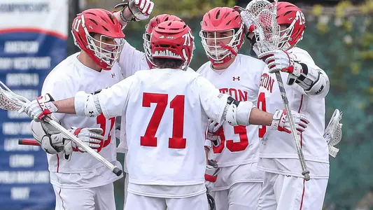 The men's lacrosse team celebrates a goal