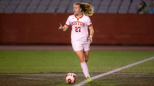Photo of Anna Heilferty dribbling with the ball at Nickerson Field.