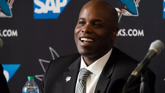 Mike Grier smiling at his introductory press conference as general manager of the San Jose Sharks