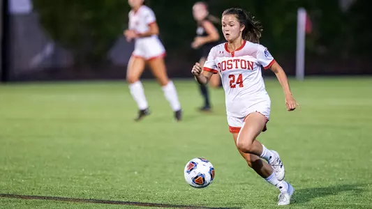 Lily Matthews dribbles with the ball against Northeastern.