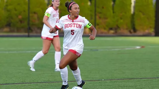 Mikayla Alcorn dribbles the ball while looking for an open Terrier.