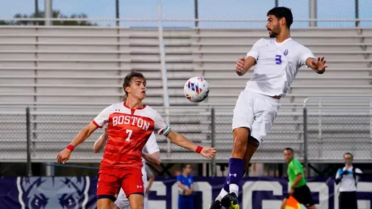 Quinn Matulis gets ready to handle a landing ball as an Albany player flies up in the air