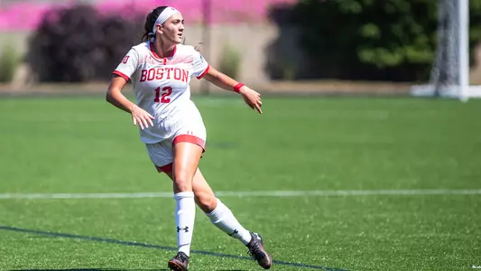 Photo of women's soccer junior Grace Ferrara after kicking the ball.