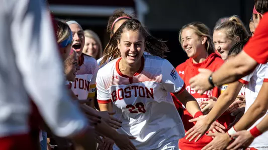 Kayla Ross high-fives her teammates as she rolls through the starting lineup