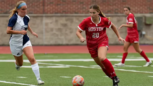 Photo of women's soccer freshman Natalie Godoy dribbling the ball against UNH.