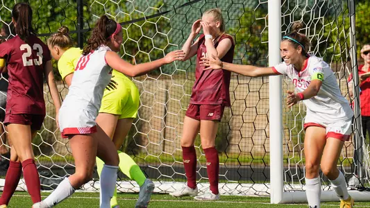 Photo of Abigail McNulty and Amy Thompson about to embrace after Thompson's goal against BC.