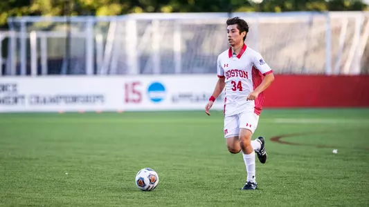 Kevin Torres dribbles the soccer ball up the field.