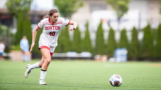 Photo of women's soccer redshirt senior Jenna Oldham dribbling the ball in space.