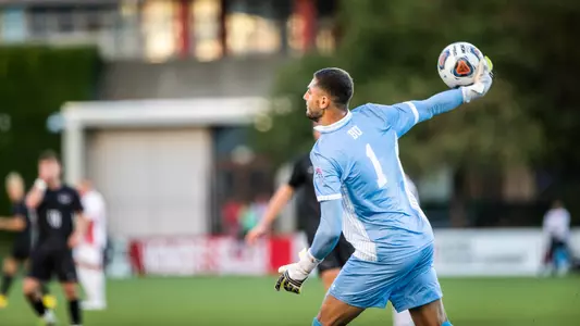 Francesco Montali pulls back his arm with the ball in hand for a long pass.