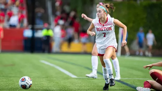 Photo of women's soccer sophomore Eileen Solomon clearing the ball against Boston College.