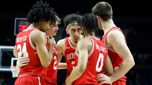 Five Men's Basketball Players huddle