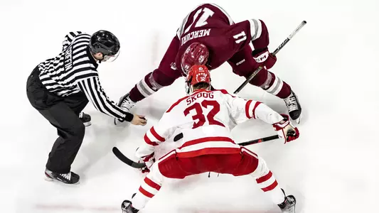 View from above of a faceoff between Wilmer Skoog and a UMass skater