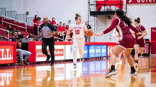 Photo of women's basketball sophomore Alex Giannaros dribbling up the court against Colgate.