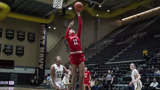 Photo of women's basketball junior Caitlin Weimar going for a layup against Army West Point.