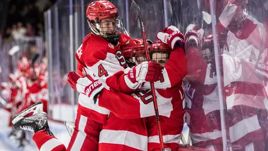 The men's ice hockey team celebrates a goal