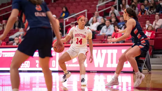 Photo of women's basketball senior Sydney Johnson dribbling the ball against Bucknell.