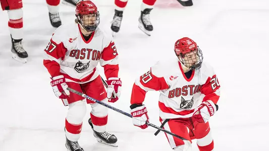 Matt Brown skating behind Lane Hutson