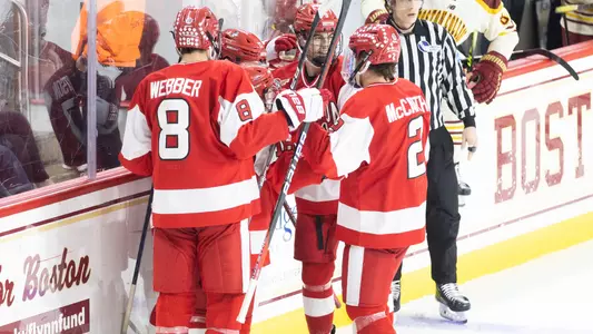 The men's ice hockey team celebrates a goal at BC