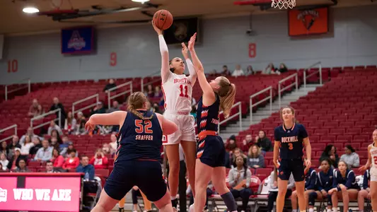 Photo of women's basketball junior Caitlin Weimar going for a hook shot against Bucknell.