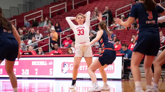 Photo of women's basketball senior Maren Durant holding the ball over her head.