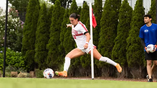 Photo of women's soccer senior Abigail McNulty inserting a corner kick.
