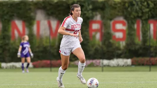 Photo of women's soccer sophomore Morgan Weaver dribbling up the field.