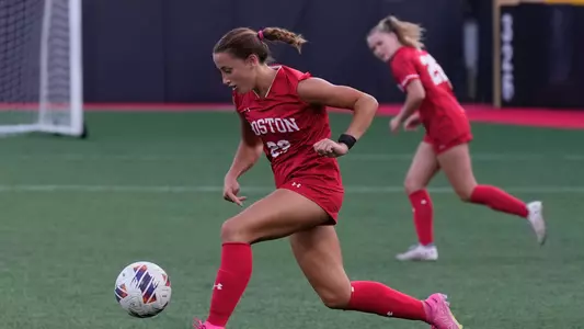 Photo of women's soccer junior Morgan Fagan dribbling the ball against Northeastern.