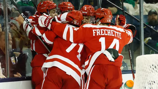 The men's ice hockey team celebrates a goal at Notre Dame
