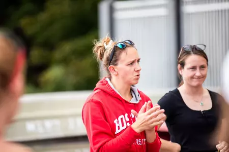 Photo of BU Lightweight Rowing Head Coach Mary Foster addressing the team at practice.