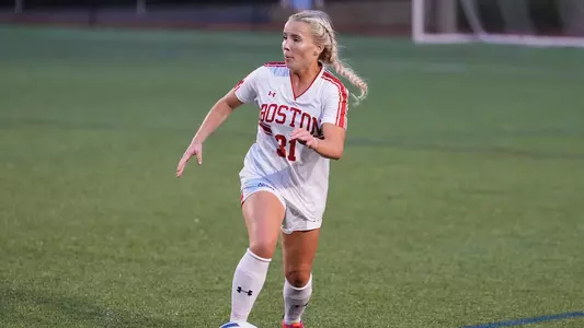 Photo of women's soccer junior Hugrún Helgadóttir dribbling the ball at Nickerson Field.