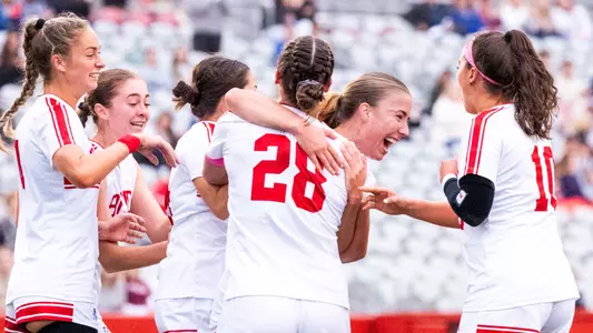 Photo of the Women's Soccer team celebrating a Natalie Godoy goal.
