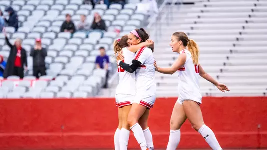 Photo of women's soccer senior Abigail McNulty receiving hugs from her teammates following her goal against Lafayette.