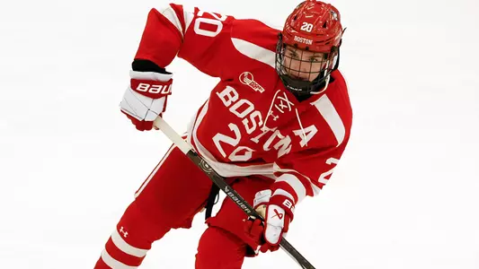 Lane Hutson passing a puck