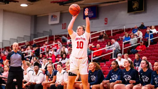 Photo of women's basketball junior Alex Giannaros shooting a three-pointer against UNH.