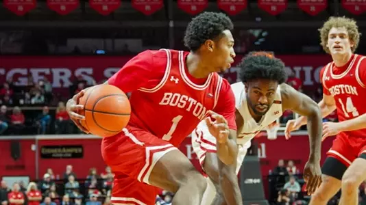 Ethan Okwuosa drives past a Rutgers defender